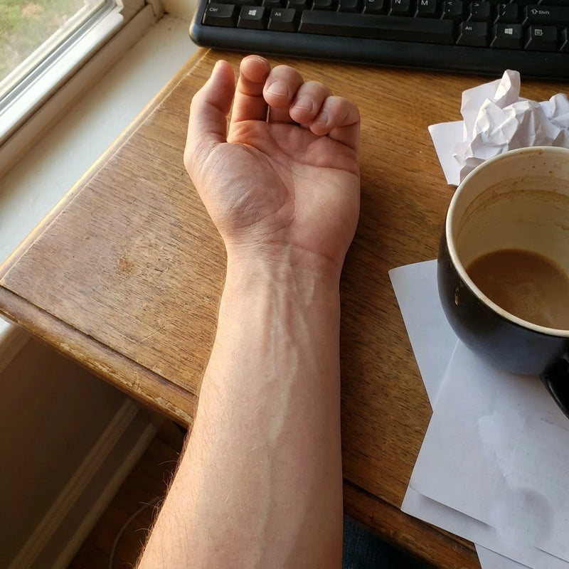 Tired wrist resting on a desk after a full day of typing