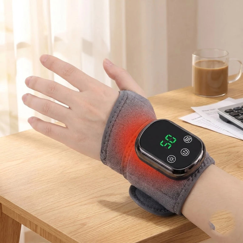 Relaxed hand wearing the Wellivu heated wrist massager on the couch